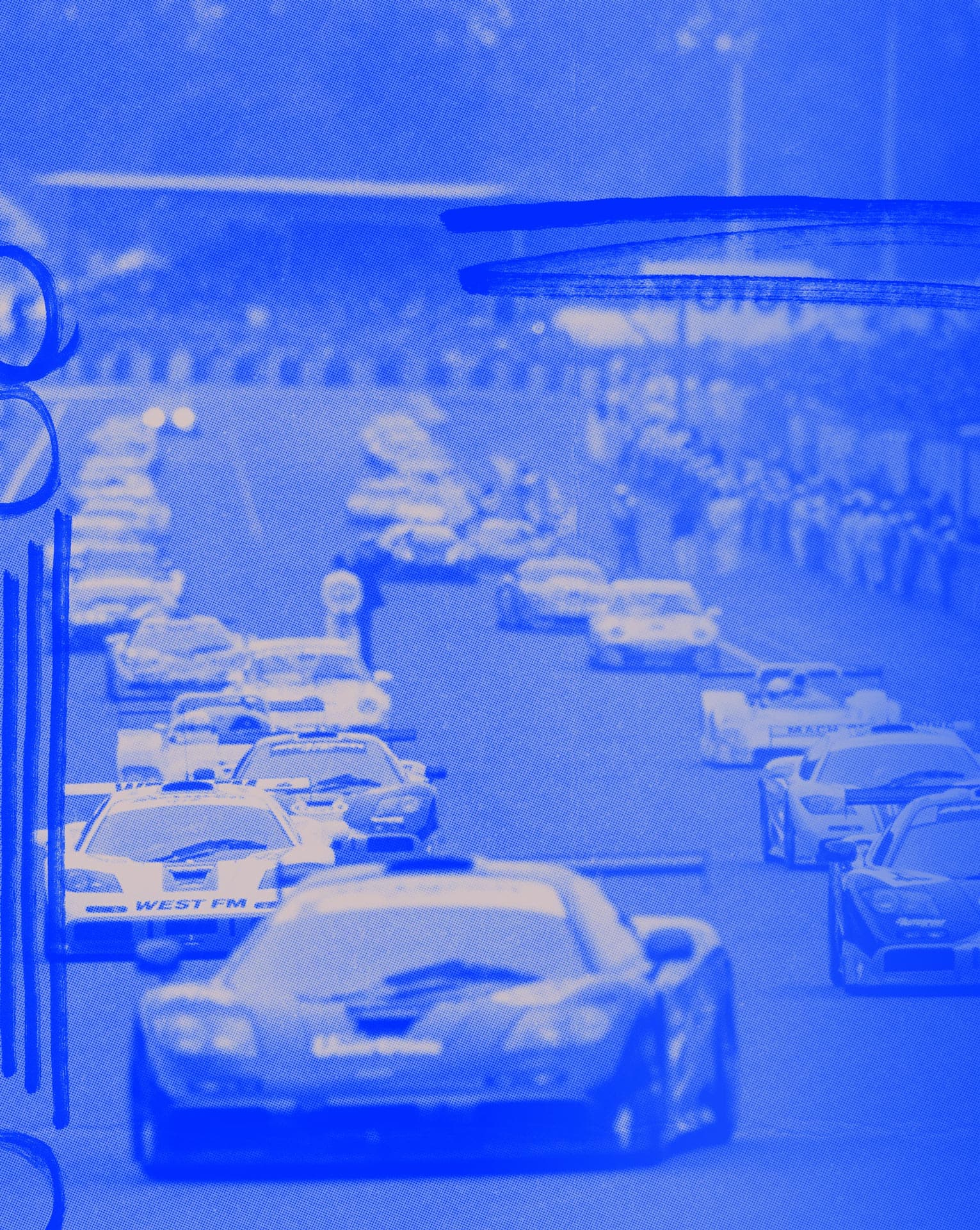 A vintage-style image with a heavy blue filter showing a pack of McLaren F1 GTR race cars and other competitors on a racetrack.