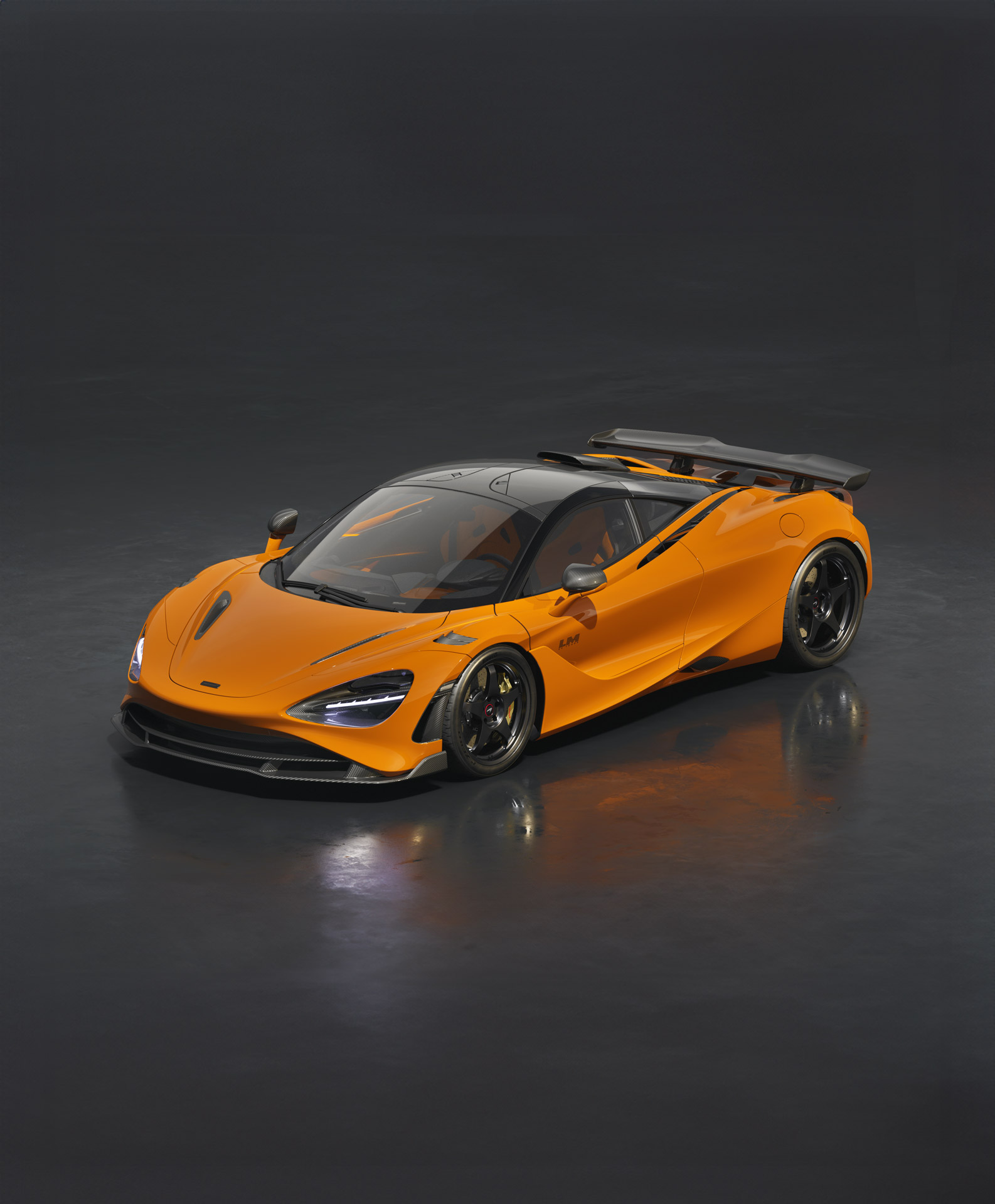 The orange McLaren 720S Le Mans special edition, featuring a black roof, racing seats, and unique front aero elements.