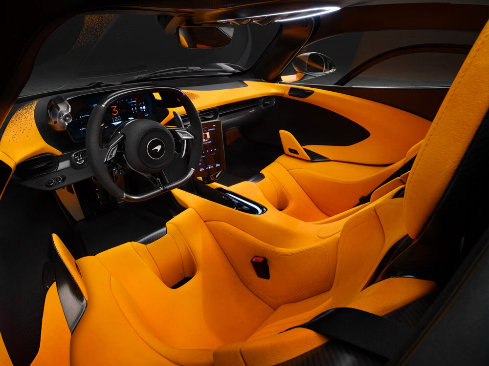 A full view of the McLaren W1 cockpit, highlighting the central driving position, digital instrument cluster, and futuristic design.