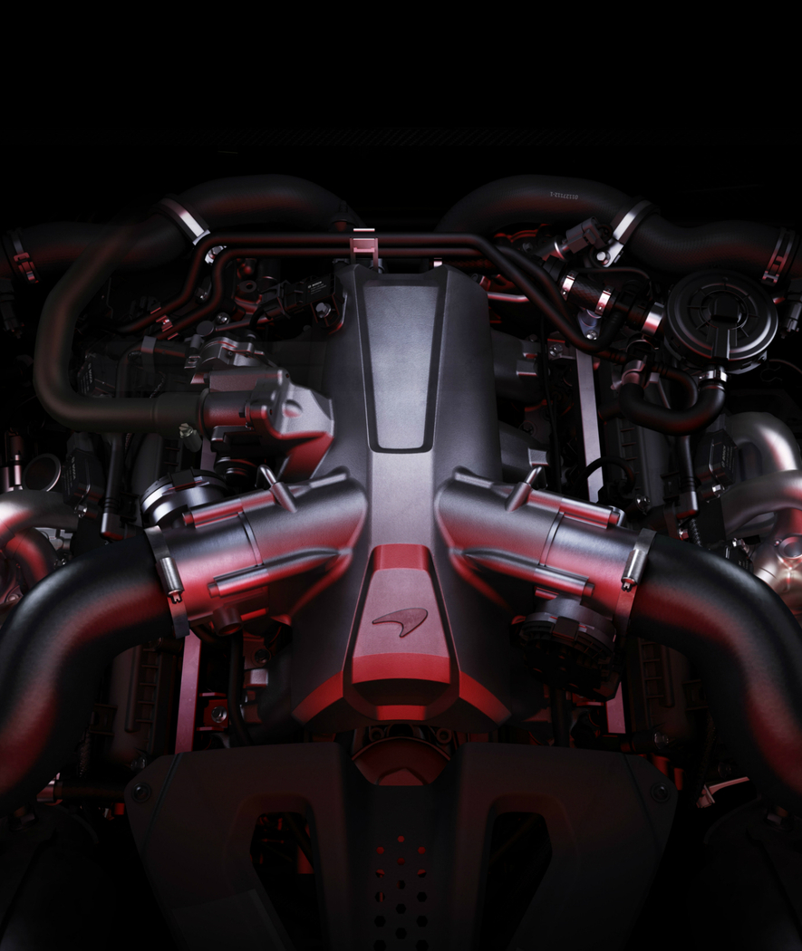 A detailed view of a McLaren M840T engine, showing its twin-turbochargers and intricate components.