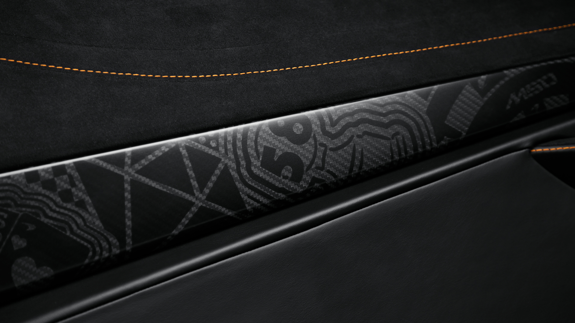 Close-up of the bespoke carbon fibre trim detail in the McLaren 750S MSO interior, featuring subtle laser-etched graphics of casino themes from the Project Viva livery.